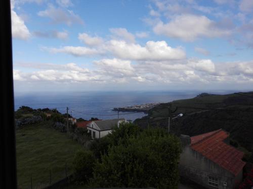 a view of the ocean from a town on a hill at Casa vicente in Santa Cruz das Flores