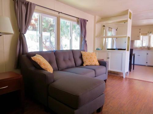 a living room with a couch and some windows at Shoshone RV Park in Shoshone