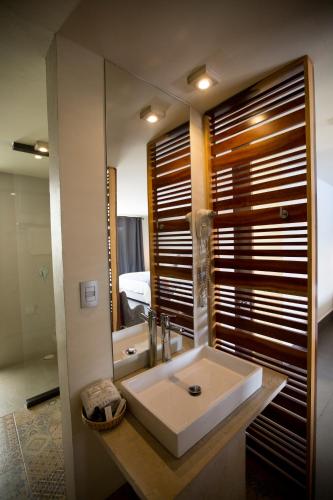 a bathroom with a sink and a mirror at Hotel Helverica in San Cristóbal de Las Casas