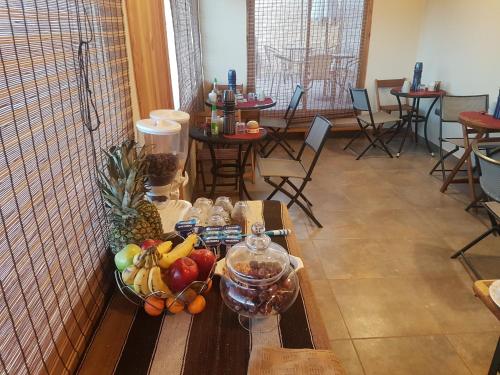 a table with a bowl of fruit on it at Vicuña Lodge in San Pedro de Atacama