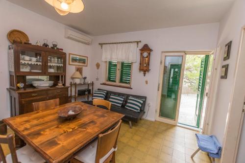 a kitchen and dining room with a wooden table at Apartments Ziva in Primošten