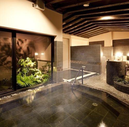 a large bathroom with a large aquarium in a room at Silk Inn Kagoshima in Kagoshima
