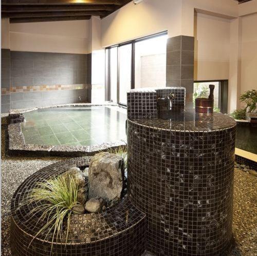 a room with a swimming pool with aitatingfficient at Silk Inn Kagoshima in Kagoshima