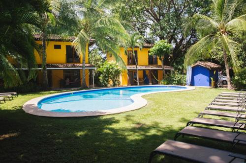 a swimming pool in the yard of a resort at Villas Macondo in Tamarindo