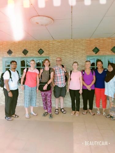 a group of people standing in a room at Homestay Damai Sri Kota in Kepala Batas
