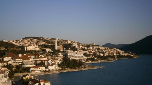 a town on a hill next to a body of water at Guest House Babić in Neum