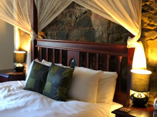 a bedroom with a bed with white sheets and pillows at Little River Bed and Breakfast in Little River
