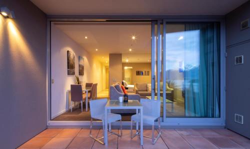 a living room with a table and chairs at Highview Apartments in Queenstown