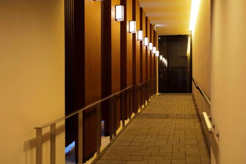 a hallway with a row of lights on the wall at karaksa hotel Sapporo in Sapporo