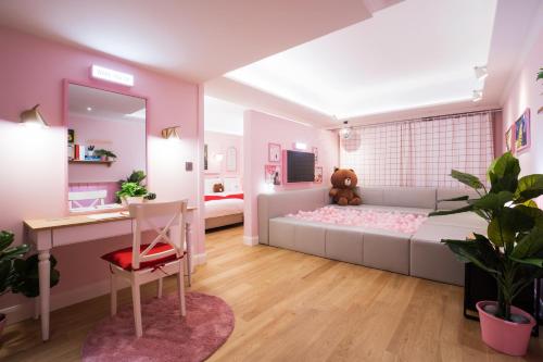 a pink bedroom with a bed and a desk at Sotetsu Hotels The Splaisir Seoul Myeongdong in Seoul