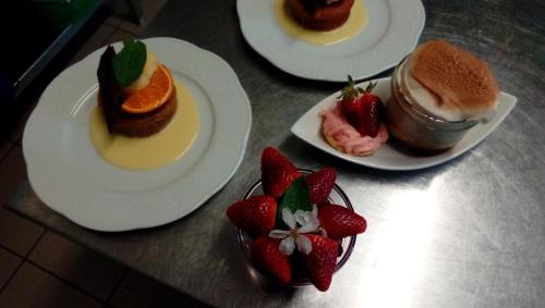three plates of desserts on a table with strawberries at Chez Louis chambres d'hôtes à la ferme in La Canourgue