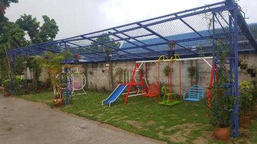 a play area with a playground in a building at Meaungkorn Villa in Fang