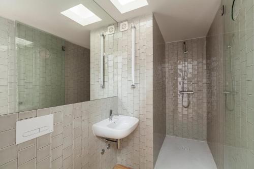 a bathroom with a sink and a shower at Villa Lóios by Casa do Conto in Porto