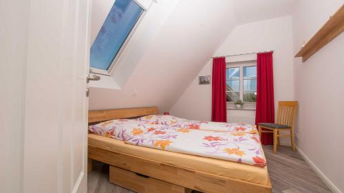 a small bedroom with a bed and a window at Herta Kruse Ferienwohnungen in Jork