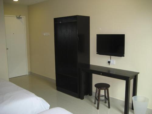 a bedroom with a black desk with a flat screen tv at Festival Boutique Hotel in Kuala Lumpur