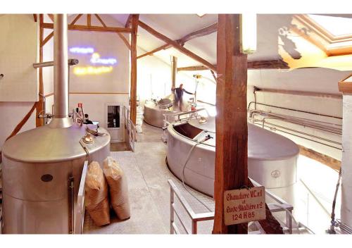 a room with three sinks and a bath tub at Maison 25 in Houffalize