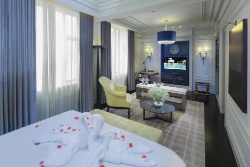 a hotel room with two beds and a living room at Golden Tulip Bund New Asia (The Former Jinjiang Metropolo Hotel Classiq Shanghai,Rock Bund) in Shanghai
