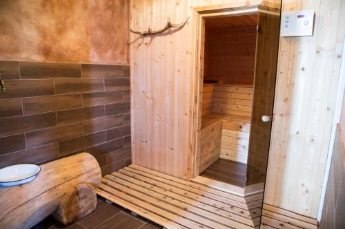 a wooden sauna with a wooden bench in a room at Unterer Obereggerhof in San Leonardo in Passiria