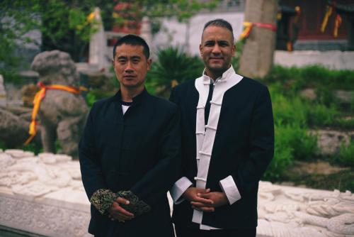 two men in suits standing in front of a statue at Koom Martial Arts Retreat & Training Center Marrakech Morocco in Had Abdallah Rhiat