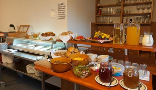 a kitchen with a table with food on it at Pension Katty in Špindlerův Mlýn