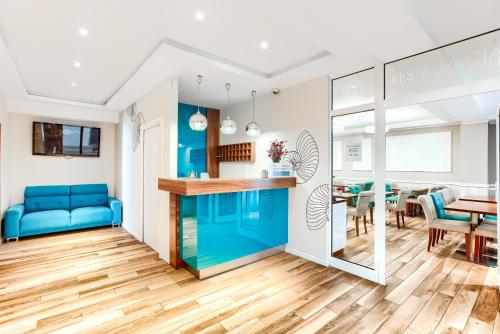 a living room and dining room with a blue couch at Apartamenty AmberHome in Międzyzdroje