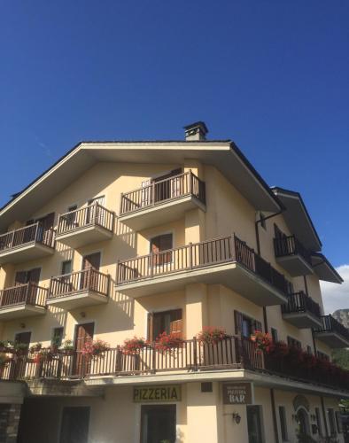 a large building with balconies and flowers on it at Hotel Ristorante Château in Aymavilles