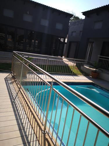 a metal railing next to a swimming pool at Mmakgabo Boutique Lodge in Bela-Bela
