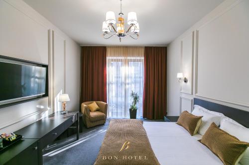 a hotel room with a bed and a large window at Bon Hotel in Dnipro