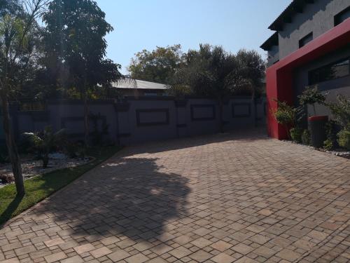 a brick driveway in front of a house at Mmakgabo Boutique Lodge in Bela-Bela