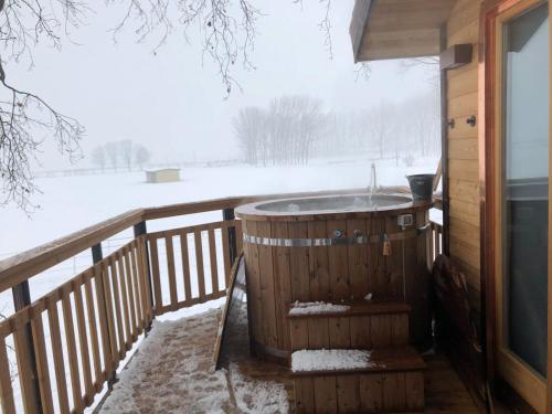 a hot tub on a deck in the snow at Agriturismo Tenuta "Il Cigno" in Villanterio