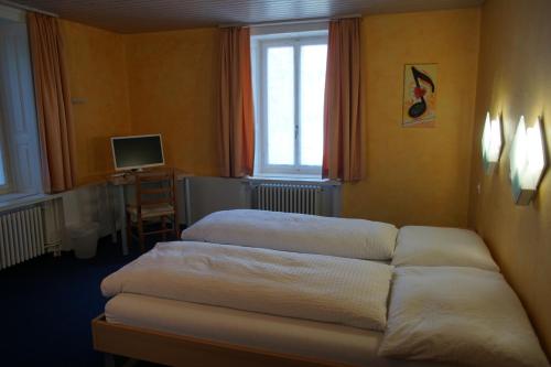 twee bedden in een kamer met een raam bij Hotel Gotthard in Brugg