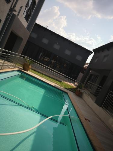 a swimming pool in front of a building at Mmakgabo Boutique Lodge in Bela-Bela