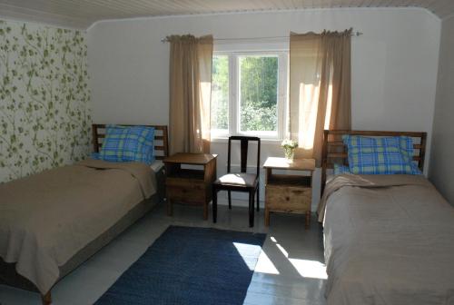 A bed or beds in a room at Hännilän Tila