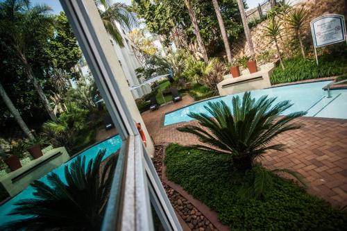 a view of a swimming pool from a balcony at StayEasy Pretoria in Pretoria