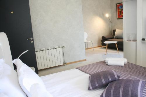a bedroom with a bed and a living room at Hotel Perfect in Varna City