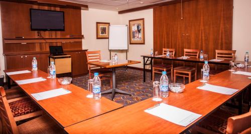 a conference room with tables and bottles of water at StayEasy Pretoria in Pretoria