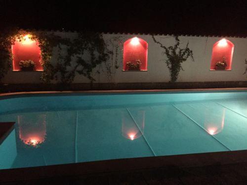 a swimming pool at night with red lights at San Marco Villas in Kranevo