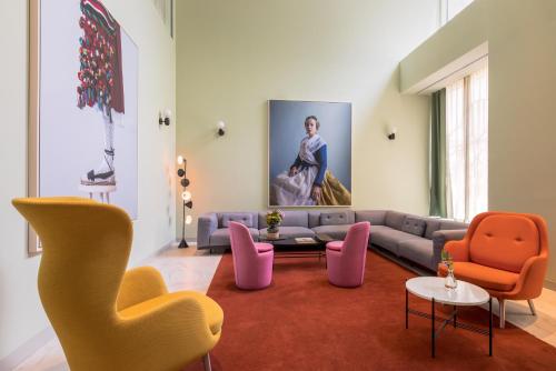 a living room with a couch and chairs at Barceló Torre de Madrid in Madrid