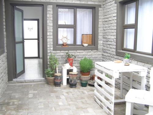 a patio with potted plants next to a building at LA CASETTA BED & BREAKFAST in Swakopmund