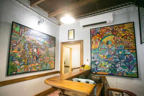 a room with a large painting on the wall at Barn1920s Hostel in Vientiane