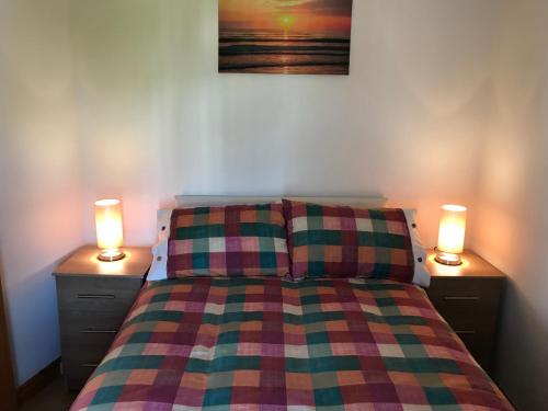 a bedroom with a bed with two lights on it at Mountain View in Newcastle