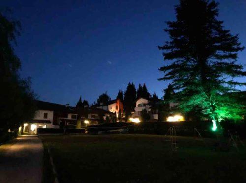 a night scene of a street with a tree and lights at San Marco Villas in Kranevo