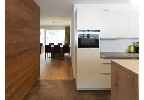 cocina con electrodomésticos blancos y comedor en Bergzauber Appartements, en Brand
