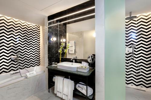 a bathroom with a sink and a mirror at Barceló Torre de Madrid in Madrid