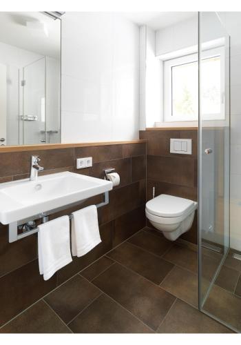 a bathroom with a sink and a toilet at Bergzauber Appartements in Brand