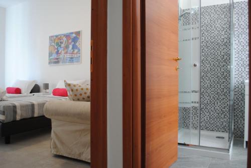 a bedroom with a bed and a glass door at BNBOOK - Galbiati Flat in Lissone