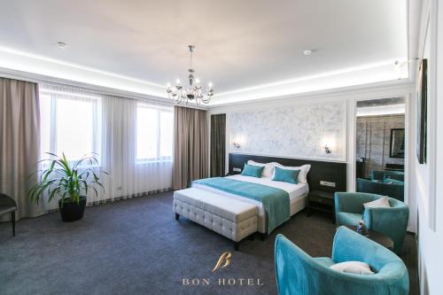 a hotel room with a bed and two chairs at Bon Hotel in Dnipro