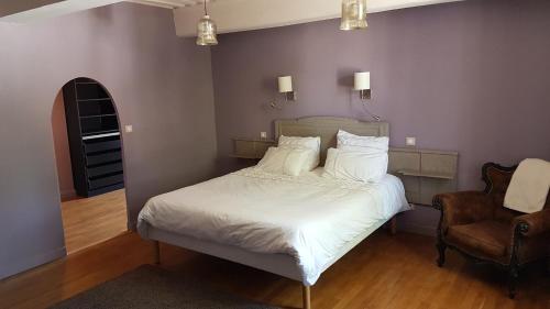 1 dormitorio con 1 cama con sábanas blancas y silla en Chambres d'hôtes Du Goût et des Couleurs, en Grenay
