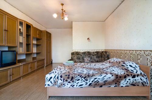 a room with a bed and a tv in it at Like A Home in Sumy