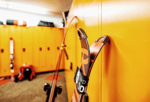 a close up of a yellow suitcase in a room at Hotel Neuhintertux 4 Sterne superior in Tux